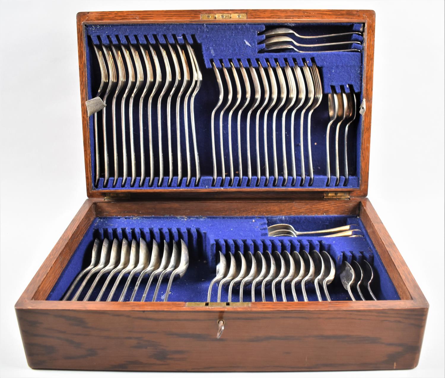 An Edwardian Oak Cased Canteen of Dixon Silver Plated Forks and Spoons Only, with Key, 42cms by