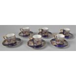 A Cobalt Blue and Gilt Set of Six Coffee Cans and Saucers Decorated in Coloured Enamels Depicting