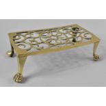 A Late 19th Century Pierced Brass Rectangular Trivet with Claw Feet, 27cms Wide