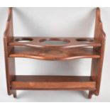 A Modern Wall Hanging Mahogany Shelf with Circular Cut Outs, 41cms Wide