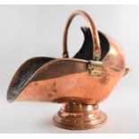 A Vintage Brass Mounted Copper Helmet Shaped Coal Scuttle with Loop Handle, 48cms Long