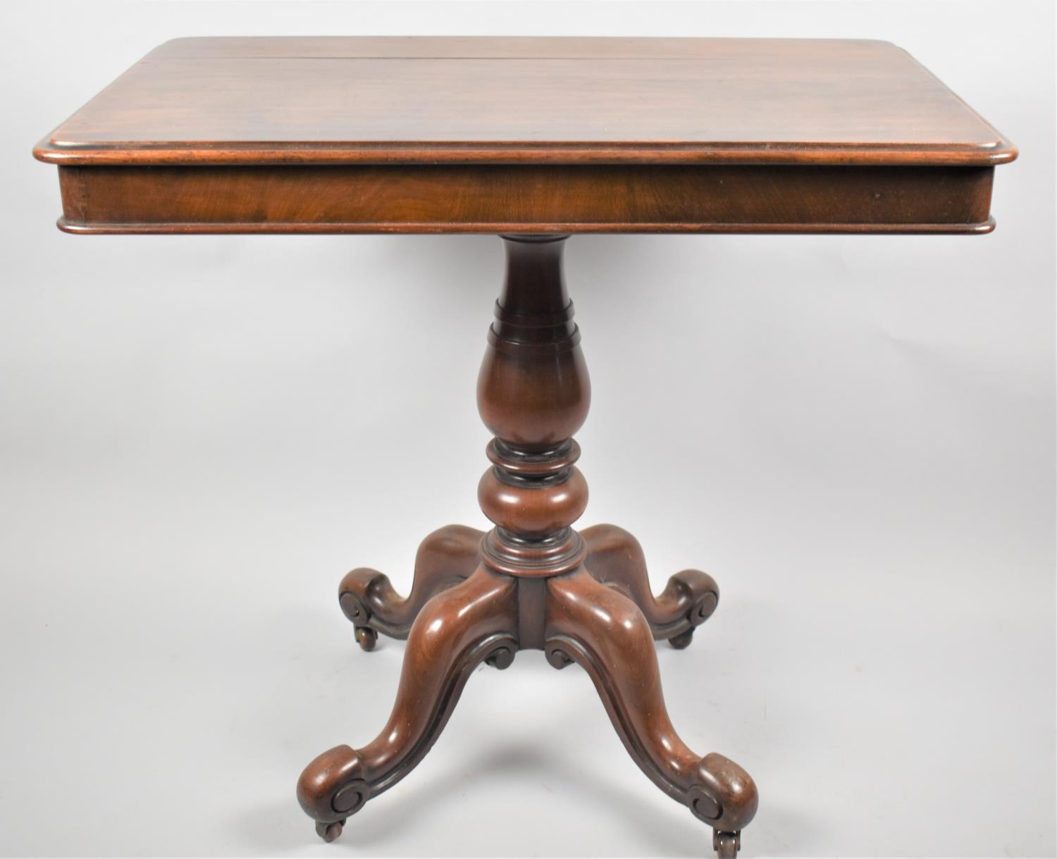 A Victorian Mahogany Rectangular Topped Occasional Table on Four scrolled Feet Culminating in