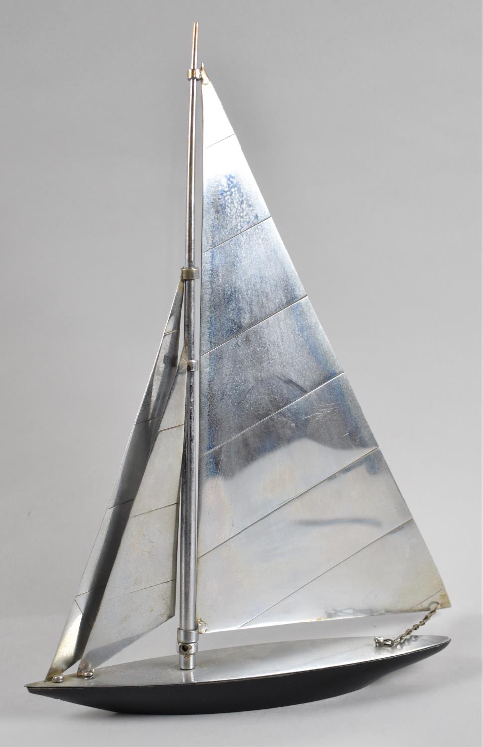 An Art Deco Chromed Metal Model of a Racing Yacht in Full Sail, 34cms High, Sail Requires Refixing