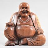 A Carved Wooden Study of Seated Smiling Buddha, 15cms High