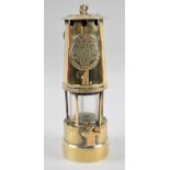 A Brass Miners Safety Lamp by the Protector Lamp and Lighting Co