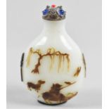 A Chinese Carved Peking Glass Snuff Bottle with Relief Carving Depicting Boy and Buffalo, White