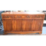 A Modern Crossbanded Yew Wood Sideboard with Three Drawers over Cupboard Base, 150cms Long