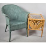 A Lloyd Loom Blue Arm Chair and a Coffee Table