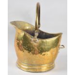 A Hand Beaten Brass Helmet Shaped Coal Scuttle, 27cm high