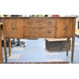 An Edwardian Mahogany Serpentine Fronted Sideboard with Two Centre Drawers Flanked by Cupboards,