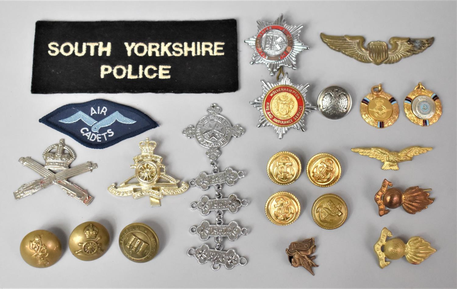 A Collection of Various Military Badges and Buttons