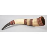 A South American Cow Horn Decorated with Leather and Braided Canework, 36cms Long