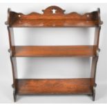 An Edwardian Mahogany Wall Hanging Three Shelf Unit with Pierced Top Gallery, 63cm Wide