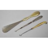 A Silver Handled Button Hook and Shoe Horn together with an Oriental Brass Handled Button Hook