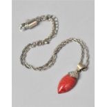 A Red Coral and Silver Mounted Pendant on a White Metal Chain