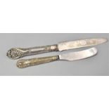A Silver Handled Butter Knife and a Silver Handled Cake Knife with Serrated Edge and Engraved Blade,