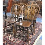 A Set of Five Oak Framed Wheel Backed Dining Chairs to Include One Carver