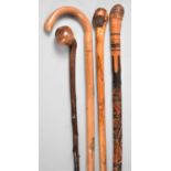 A Collection of Four Various Walking Sticks, One African Example with Knobkerrie Handle, One