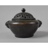 A Patinated Bronze Censer having Pierced Lid with Lion Mask Handles, 10cms Diameter