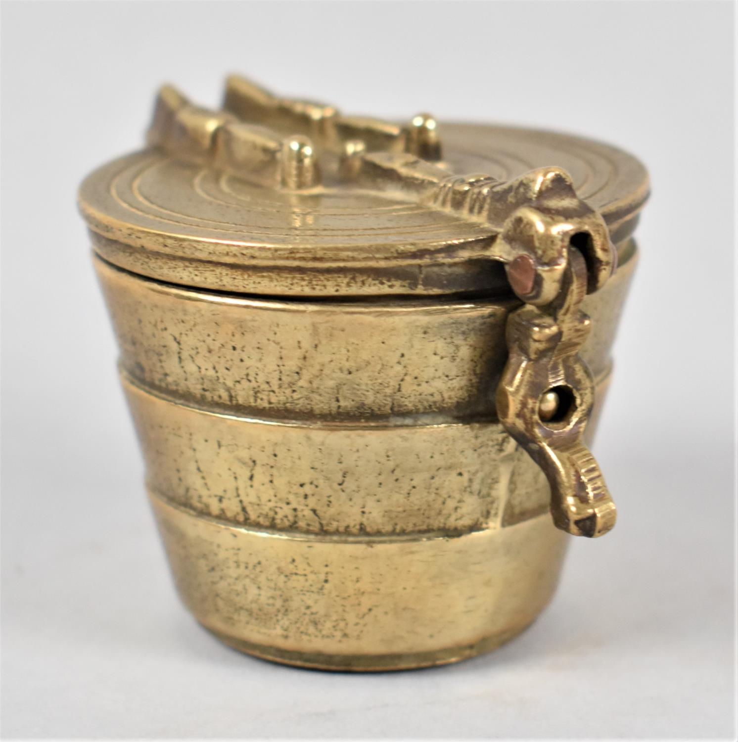 A Set of Four Cylindrical Tapering Graduated Brass Weights in Container with Hinged Lid, 5cms