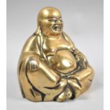 A Brass Study of a Seated Smiling Buddha, 13cm high