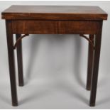 A George III Mahogany Folding Tea Table on Square Chamfered Supports, 68cm wide x 71cm high