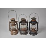 A Collection of Three Vintage Hurricane Lamps