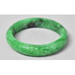 A Chinese Jadeite Bangle with Carved Scrolling Decoration 7cm Diameter