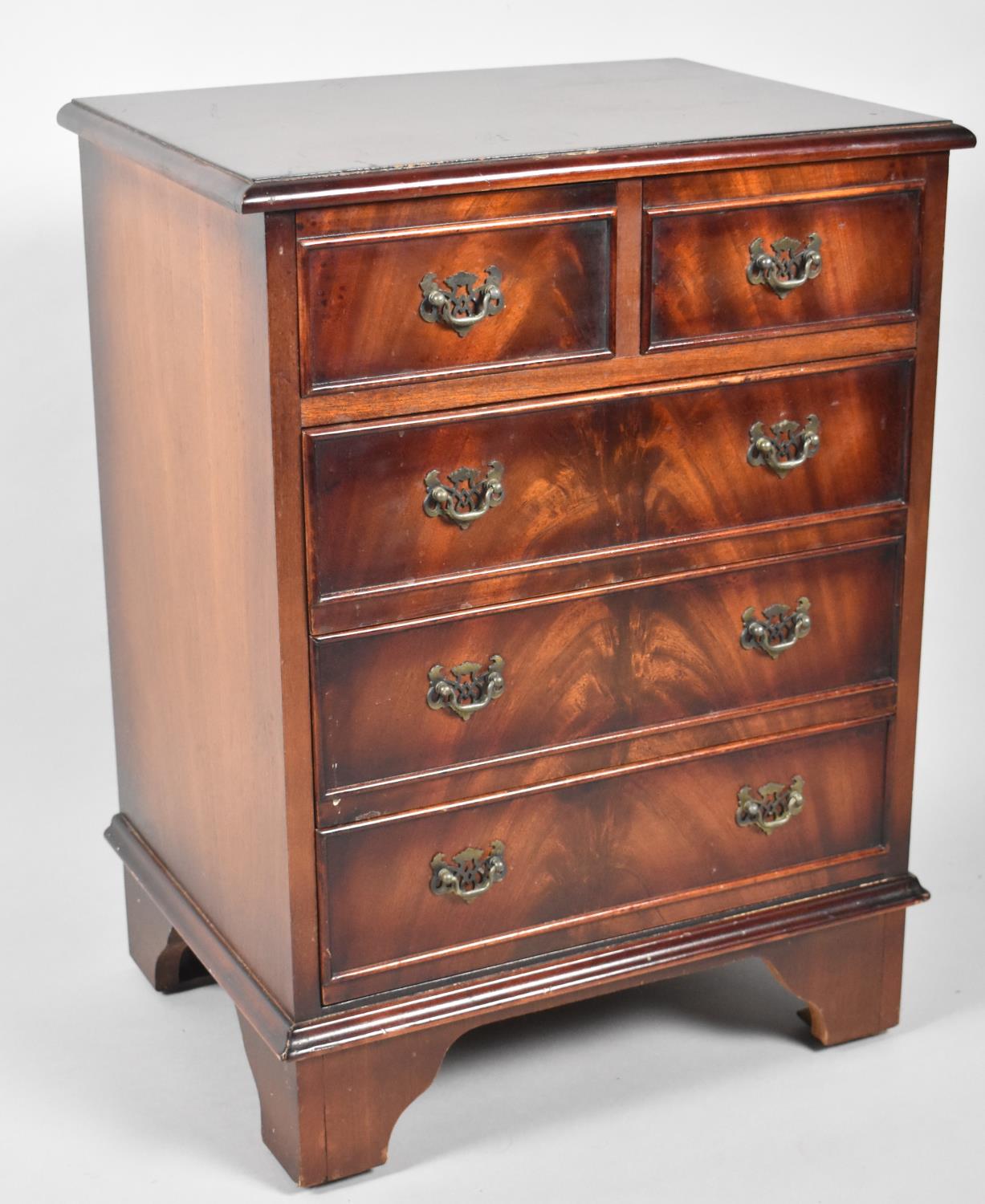 A Reproduction Mahogany Miniature Chest of Two Short and Three Long Drawers on Bracket Feet, 44cm