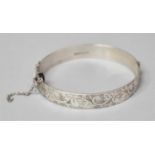 A Silver Bangle with Safety Chain, Birmingham 1963 Decorated with Engraved Scrolling