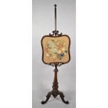 A Victorian Rosewood Pole Screen with Turned Slender Support and Carved Scrolled Tripod Feet, Having
