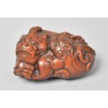 A Chinese Carved Wooden Study Of a Temple Lion with Ball and Pup, 7cm long