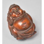 A Carved Wooden Netsuke In the Form of a Portly Ponytailed Oriental Gent, 7cm high