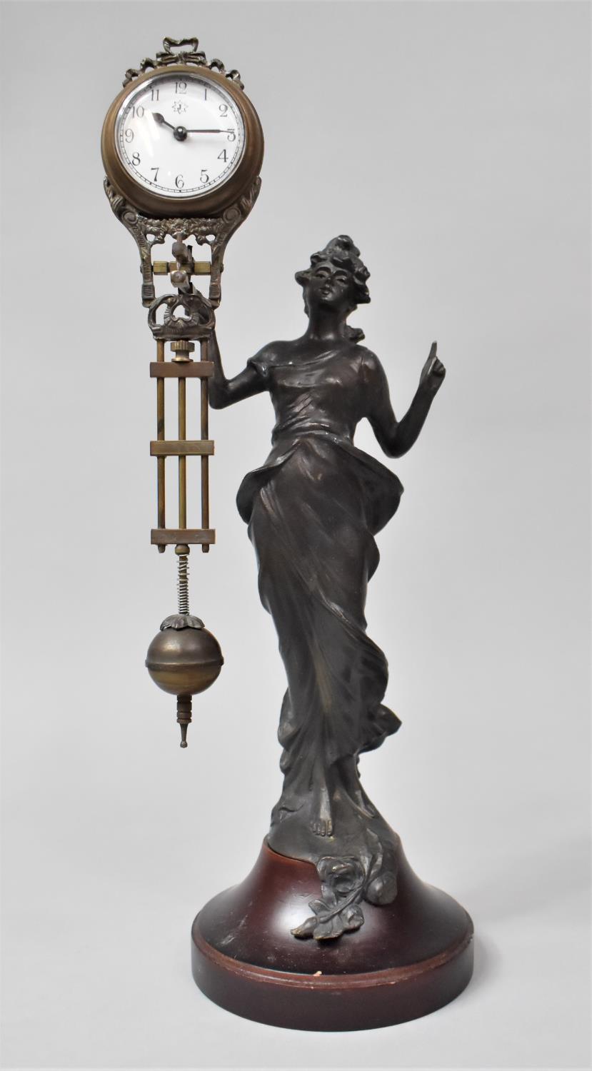 A Reproduction Bronze Spelter Mystery Clock in the Form of an At Nouveau Maiden with Finger Pointing