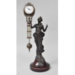 A Reproduction Bronze Spelter Mystery Clock in the Form of an At Nouveau Maiden with Finger Pointing