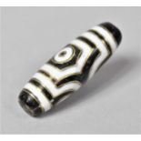 An Inlaid Agate Dzi Bead, 4cm long