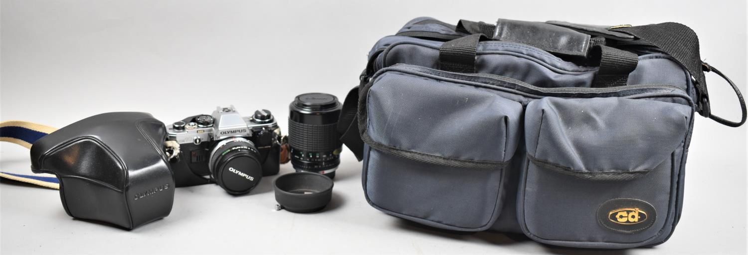 An Olympus OM10 35mm Camera Complete with Sigma Zoom Lens, Carrying Bag
