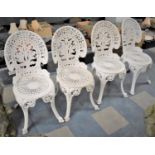 A Set of Four White Painted Cast Metal Garden Seats