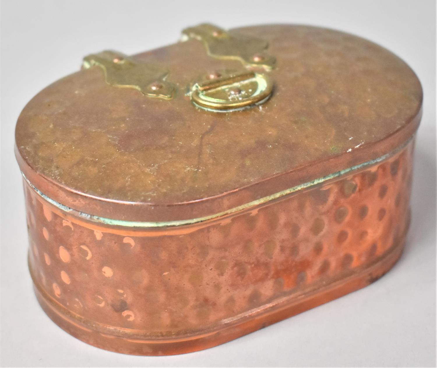 A Copper Oval Box with Brass Hinges and Handle, 11.5cm Long