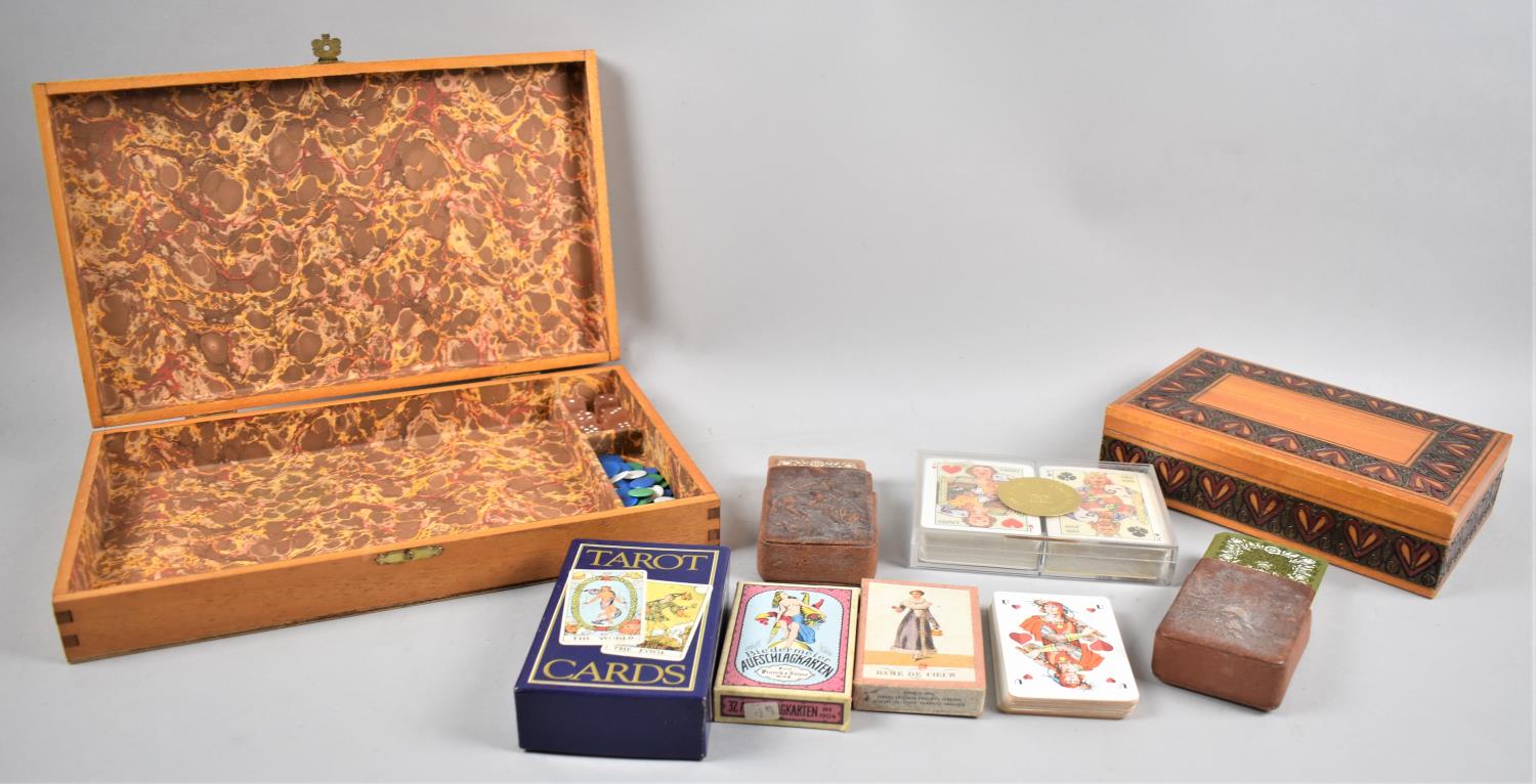 A Wooden Work Box Containing Various Playing Cards, Tarot Cards, Dice, Counters etc Together with