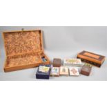 A Wooden Work Box Containing Various Playing Cards, Tarot Cards, Dice, Counters etc Together with