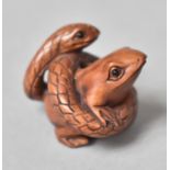 A Carved Wooden Netsuke in the form of a Snake Entwining a Frog