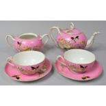 A Late 19th Century Pink Glazed Tea for Two Set Comprising Two Cups and Saucers, Teapot and Sugar
