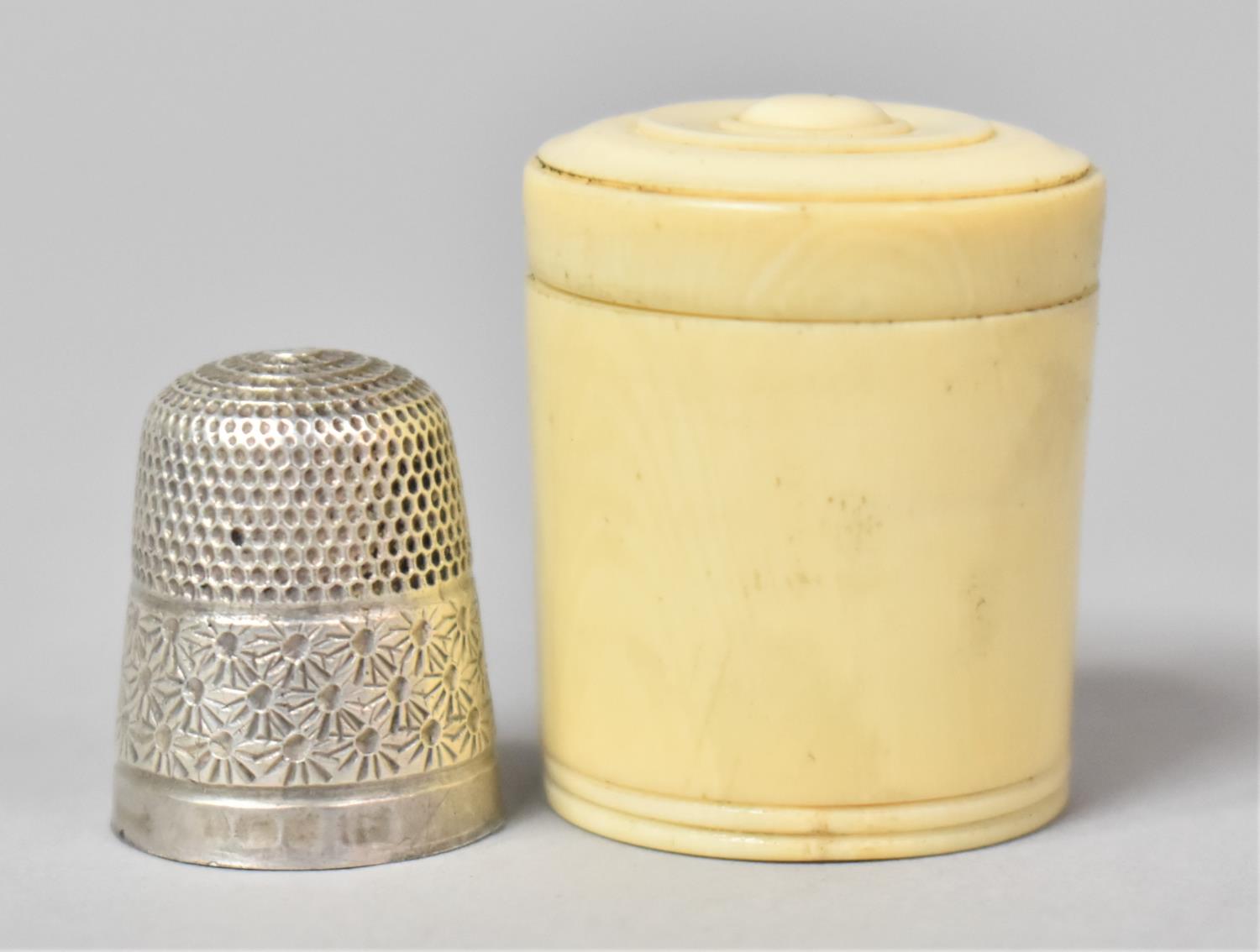 A Small Silver Thimble in Unrelated Cylindrical Box