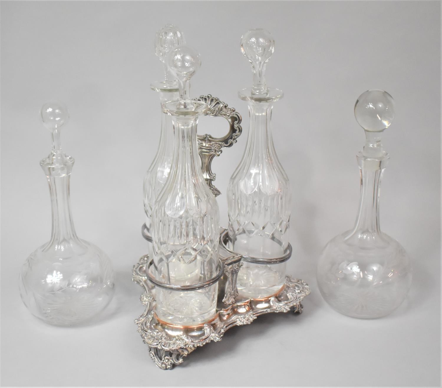 A Sheffield Plated Three Bottle Stand with Three Cut Glass Decanters, (Varying Condition Issues to