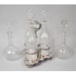 A Sheffield Plated Three Bottle Stand with Three Cut Glass Decanters, (Varying Condition Issues to