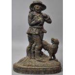 A Rusted Cast Metal Door Stop in the Form of Gent with Dog, 34cm high