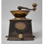 A Vintage Brass Mounted Iron Coffee Grinder by Baldwin Son & Co.