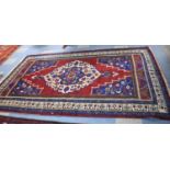 A Fine Anatolian Handmade Patterned Woollen Carpet on Red and Blue Ground, 179x293cm