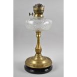A Late Victorian Brass Oil Lamp with Cut Glass Reservoir and Ebonised Circular Base, 41cm high